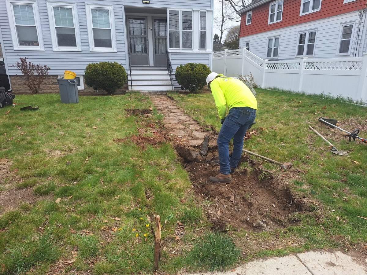 Before: old cracked brick walkway being removed