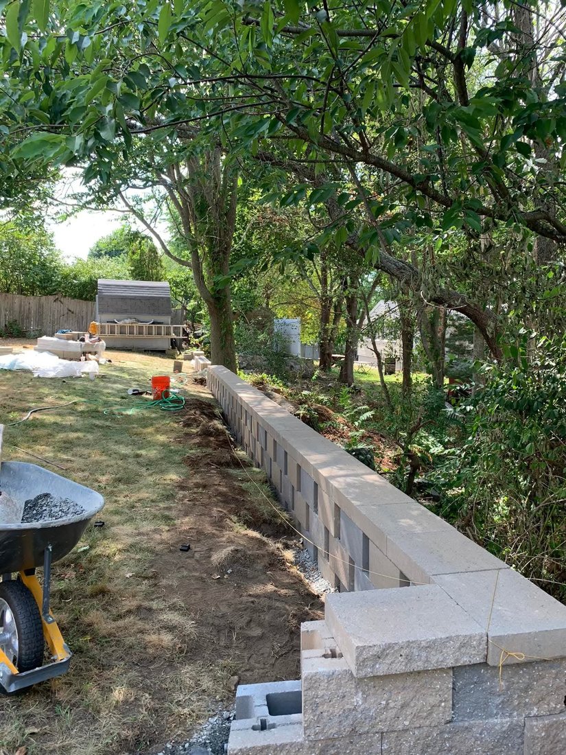 Block retaining wall under construction