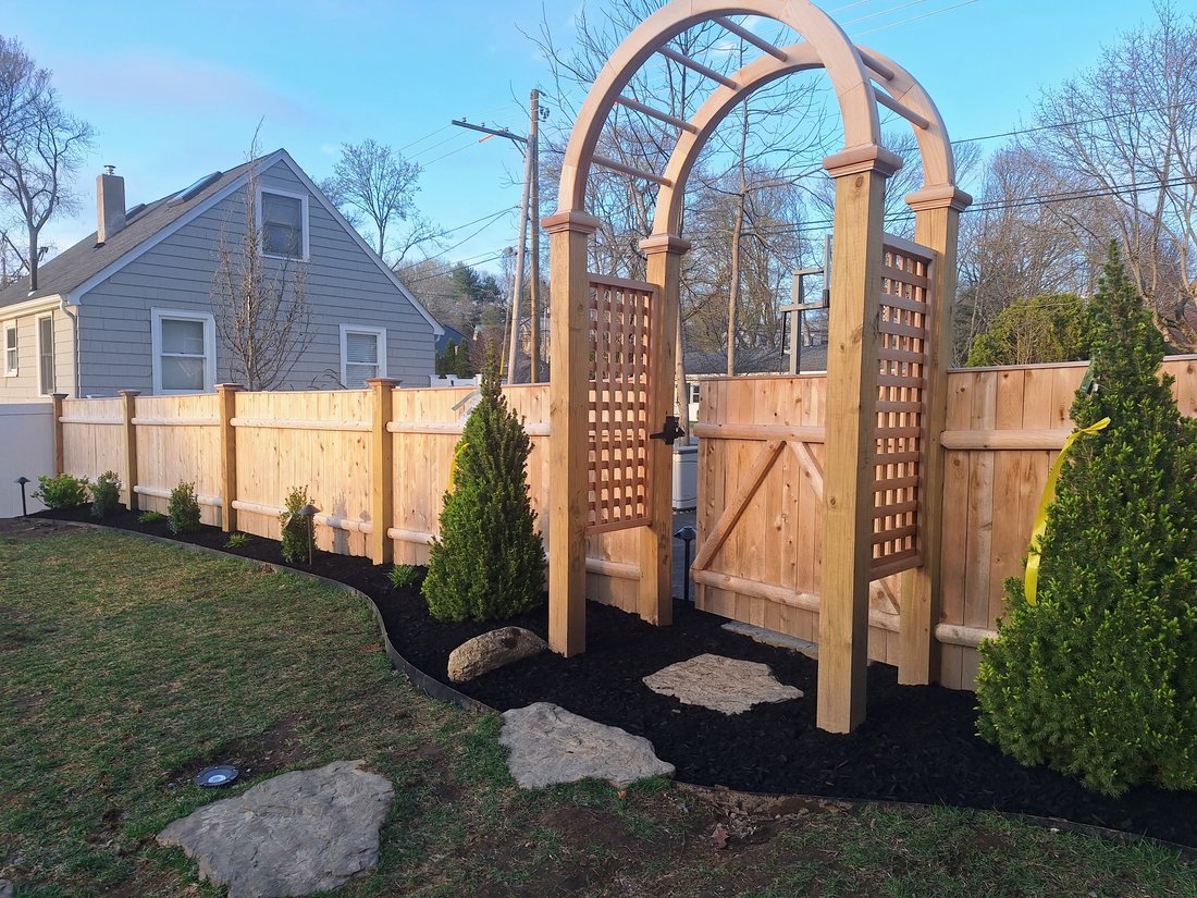 Fresh mulch bed along a new fence line